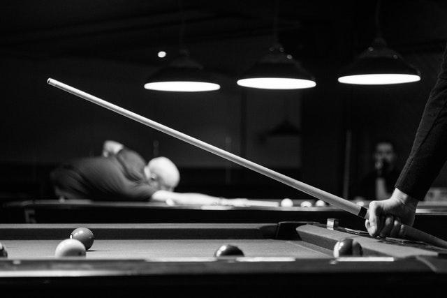 gray scale, man holding cue stick